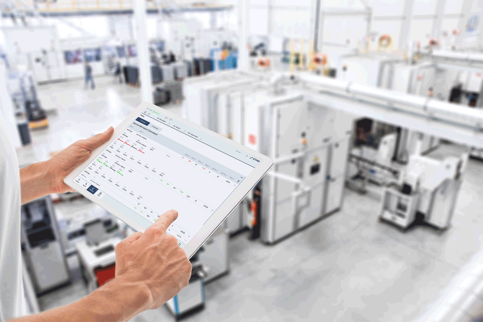 Operator monitoring production using a tablet directly on the shop floor.